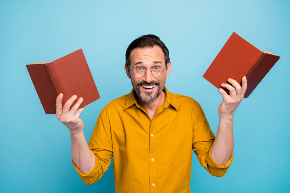 Happy man holding books