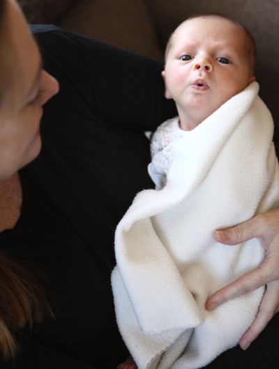 Mother holding her newborn baby girl.