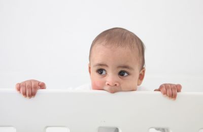 A baby in his cot.