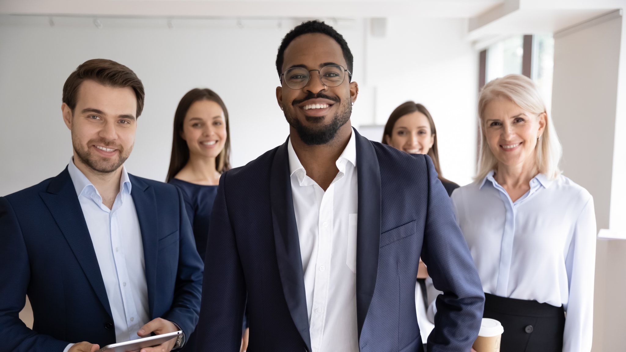 Portrait of diverse colleagues posing together in office Group portrait of smiling motivated multiracial businesspeople stand show unity and support, happy multiethnic diverse colleagues coworkers posing together in office, teamwork, leadership concept