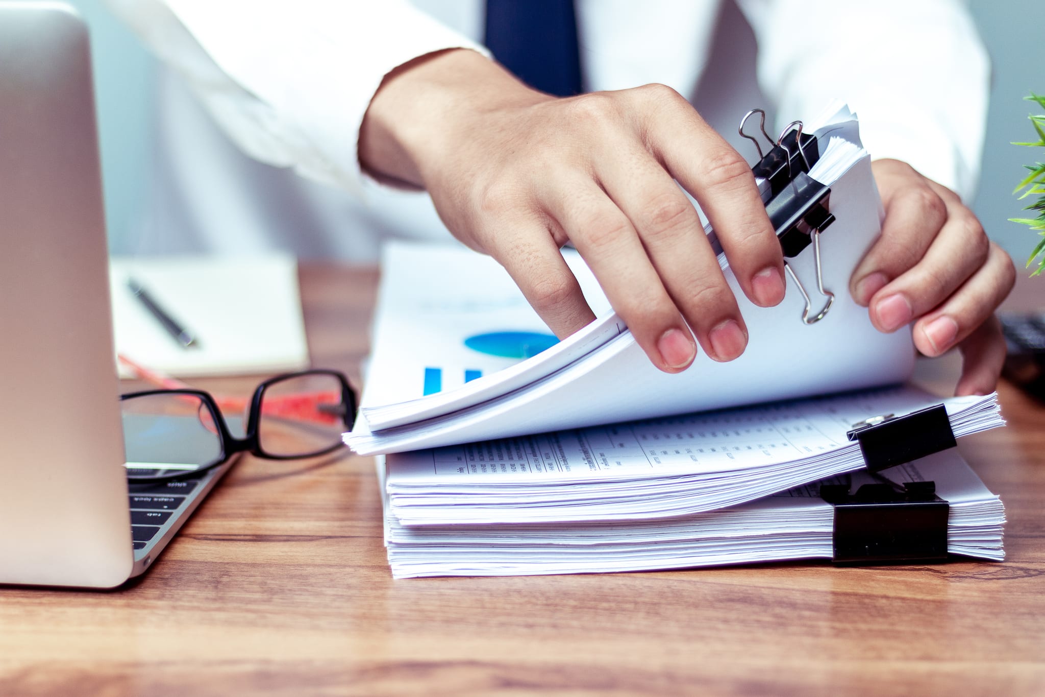 Businessmen are searching for documents lying on the table,business report papers,important documents. Businessmen are searching for documents lying on the table,business report papers,important documents.