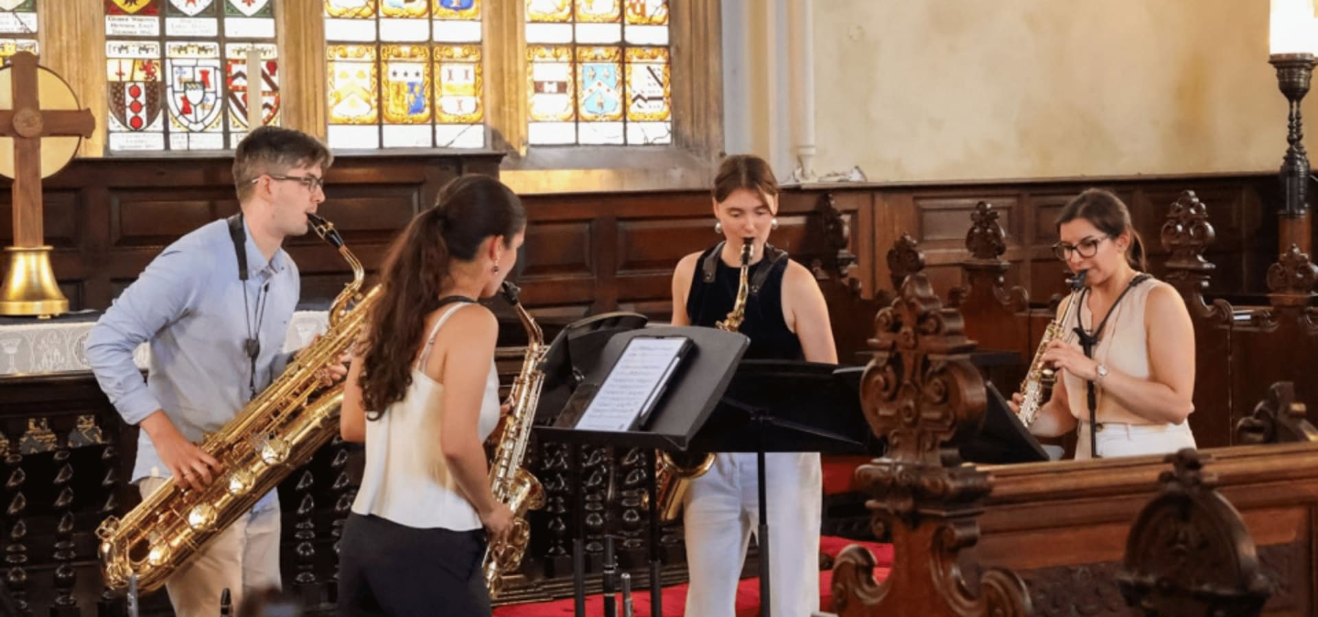 Three musicians in the Lincoln's Inn Chapel playing their instruments.