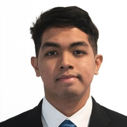 Umar Badrul Hisham faintly smiles. He is in front of a plain white background and wears and black suit, white shirt and blue satin tie.