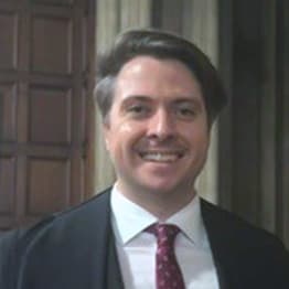 James Forrester in a suit and gown in the Great Hall