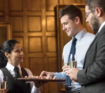 Canapes being served to guests in historic hall