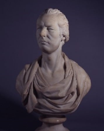 A bust of William Pitt, dressed in flowing robes, photographed in front of a grey background.