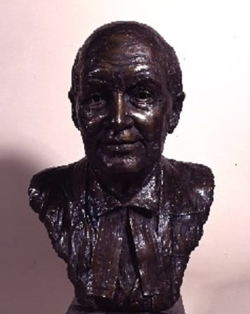 Bust of Lord Denning by Jean Roth. Lord Denning is a balding man, dressed in a shirt.