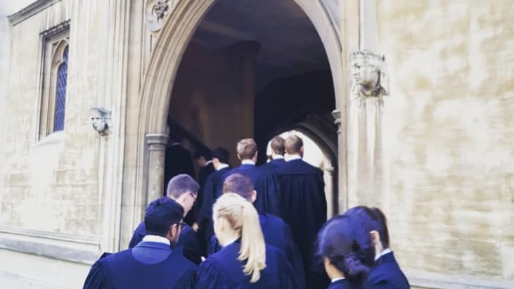 Callees dressed in gowns head into the undercroft of Lincoln's Inn.