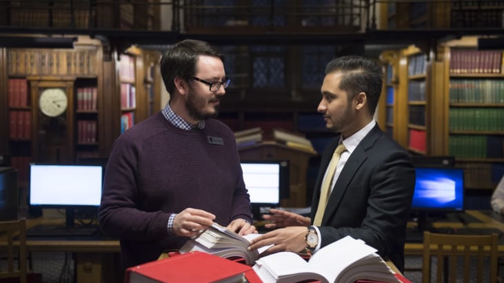 Library staff helping a user