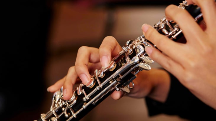 Close up of a woman's hands playing a clarinet