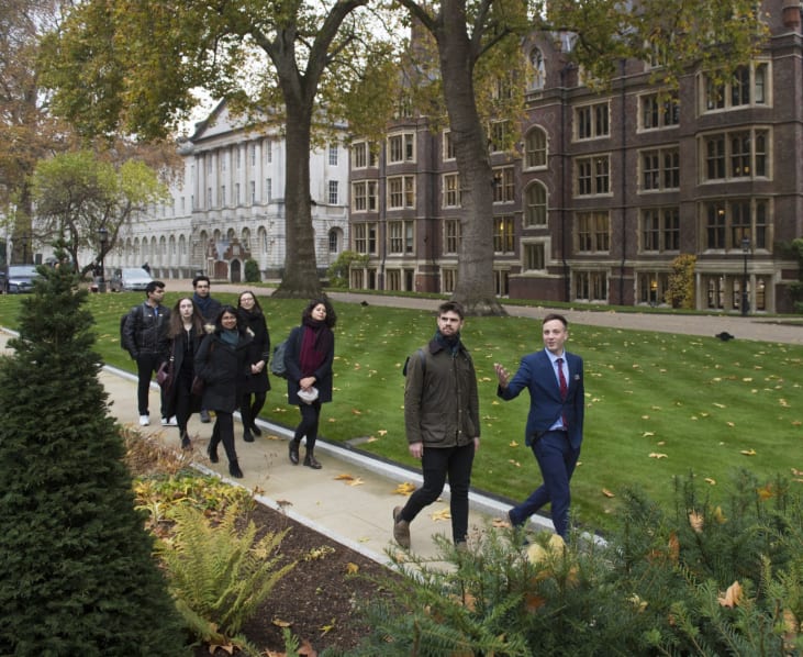 A group of people walking through the Inn's grounds