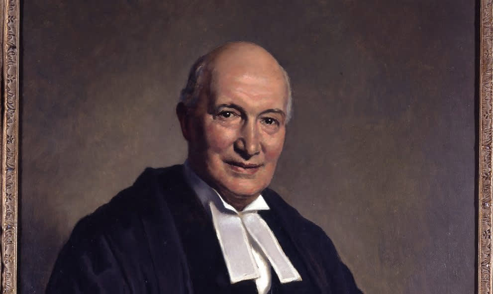 Portrait of Lord Denning, a balding white man, dressed in a black gown and a white cravat.