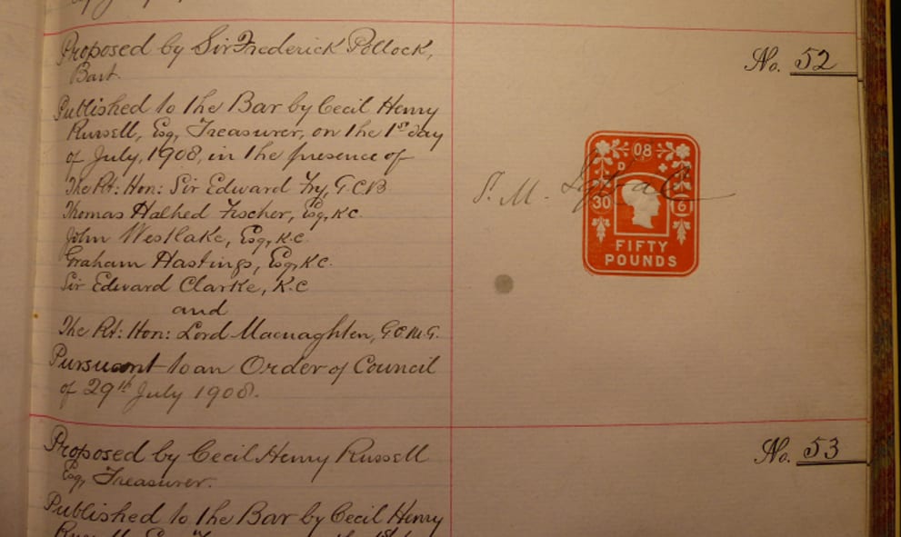 Hand written text on lined paper with a red stamp.