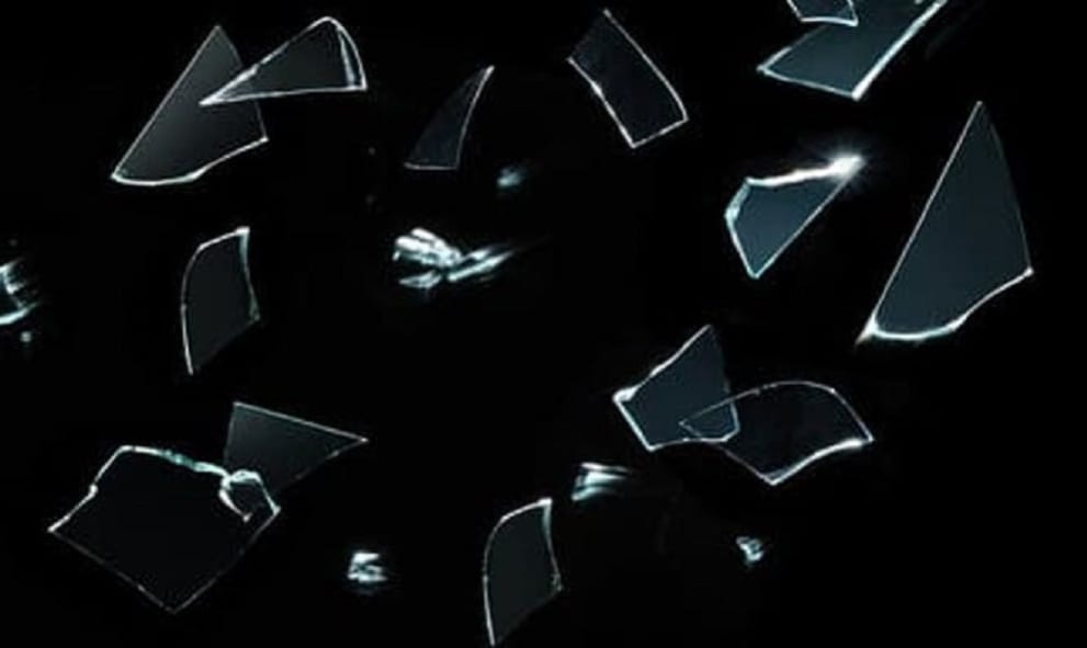 splintering glass on black background
