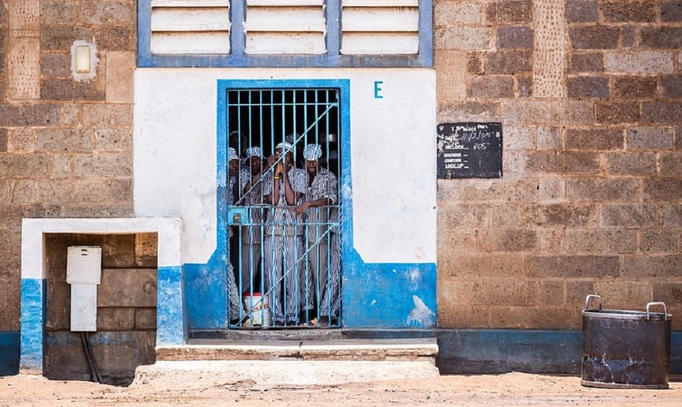 prisoners looking out from behind bars