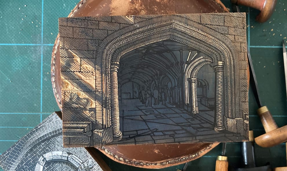 Wood block engraved with a representation of Lincoln's Inn Undercroft, next to chisels and art tools
