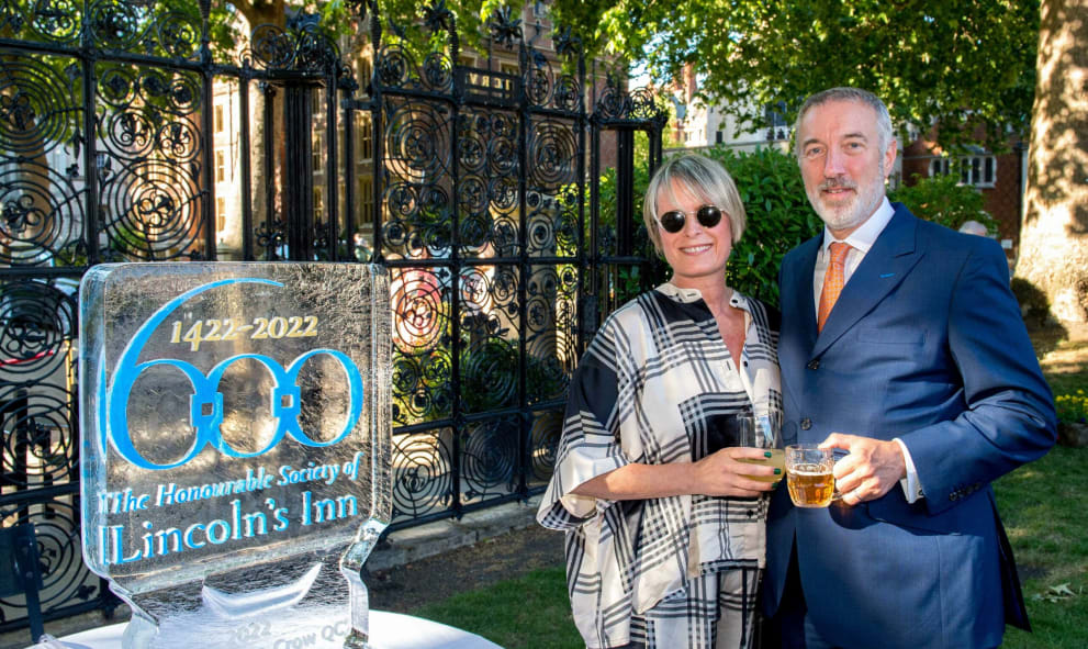 Claudia Crow and Jonathan Crow KC next to an ice sculpture at Lincoln's Inn 2022 Garden Party