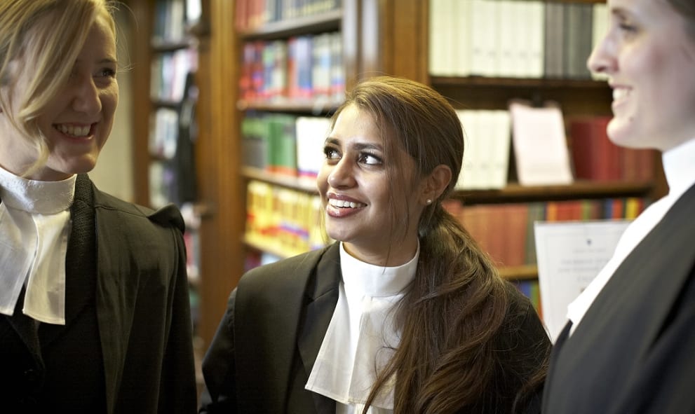 Women barristers in gowns and collars in the Lincoln's Inn Library