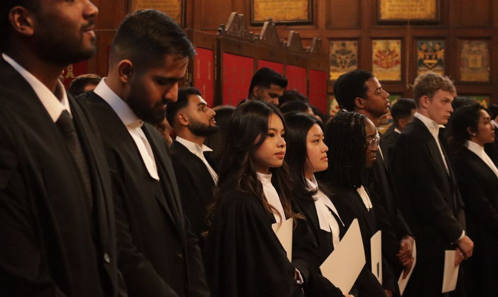 Students waiting at the back of the Great Hall.