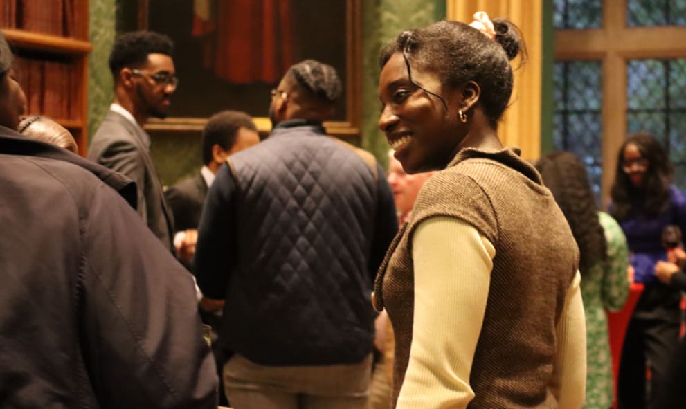 Two attendees at the Black History Month social 2025 talking to each other