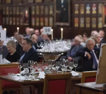 Speaker addressing guests at award ceremony in historic hall
