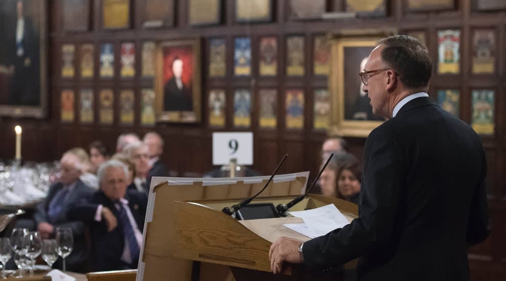 Speaker at a podium for award ceremony in historic hall