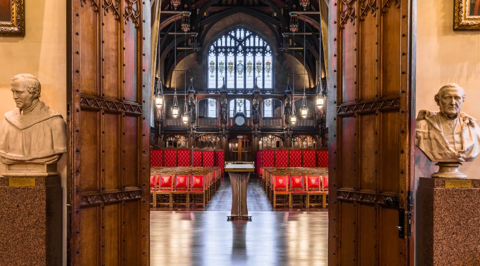 Open door with busts on either side leading to historic hall