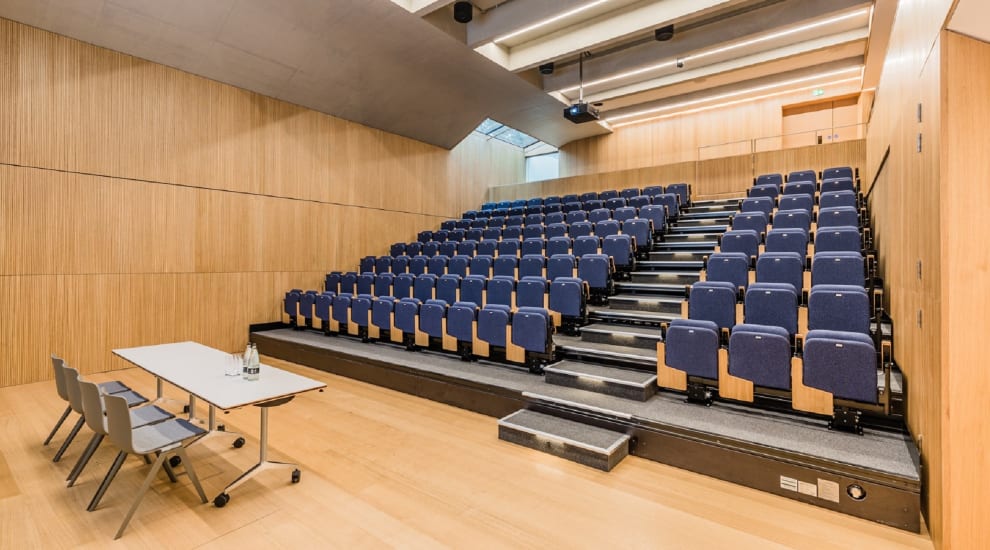 Lecture theatre from the front filled with rows of chairs