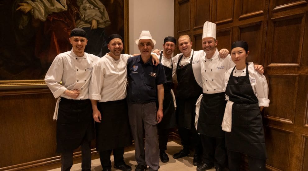Members of the catering team smiling for a group photo
