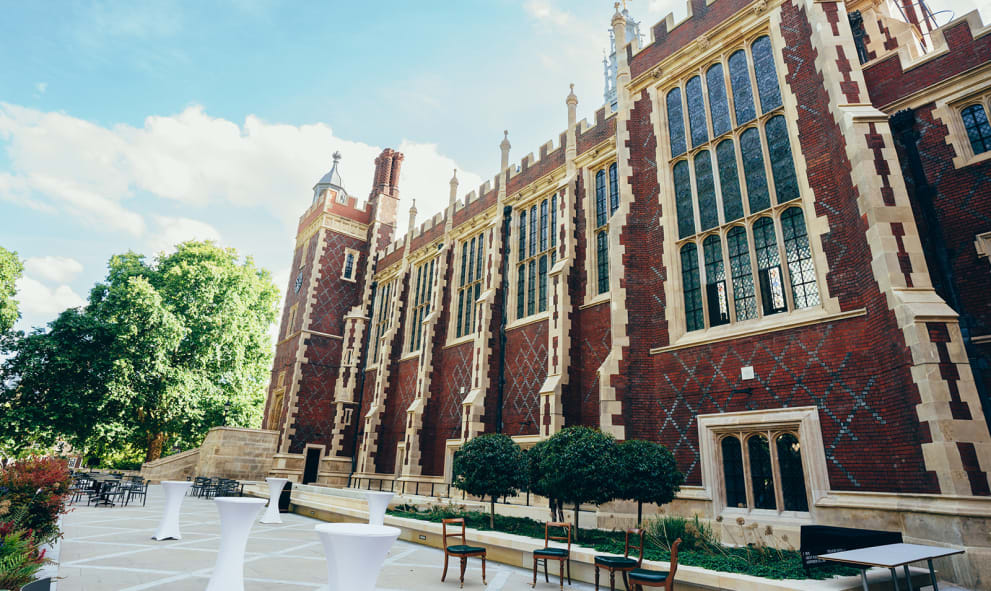 Outdoor shot of historic venue with tables set up for outdoor event