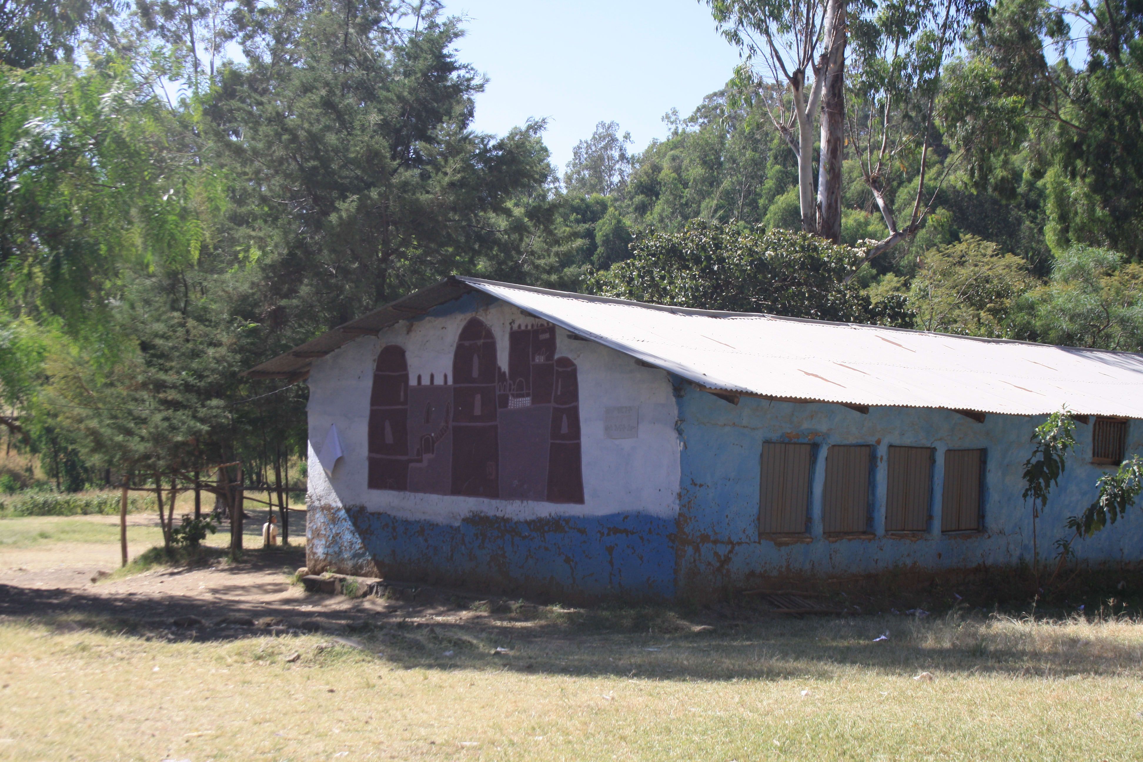 A mural of Gondar castle at Arbatu Ensesa School. This mud and wood structure with corrugated iron roof is a typical classroom design at government schools that I have seen in the North and the South. Link Ethiopia funded the metal shutters and doors to improve security and added cement flooring replacing mud and dust (which had made some children ill).