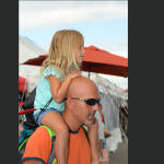 dad with daughter on shoulders