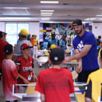 Cubs player playing ping pong with teams