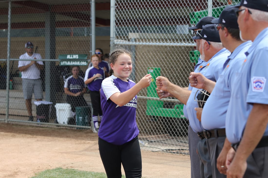 player fistbumping umpires