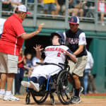challenger game - buddy pushing player in wheelchair home