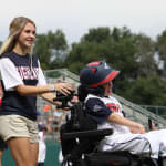 challenger game - buddy pushing player in wheelchair