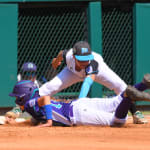 nw first baseman tagging out sliding player