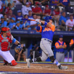 mets player swinging bat