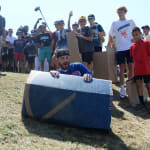 Cubs player sliding down the hill on cardboard