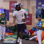 Pirates player playing cornhole with teams