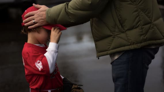 Tee Ball child with dad holding head