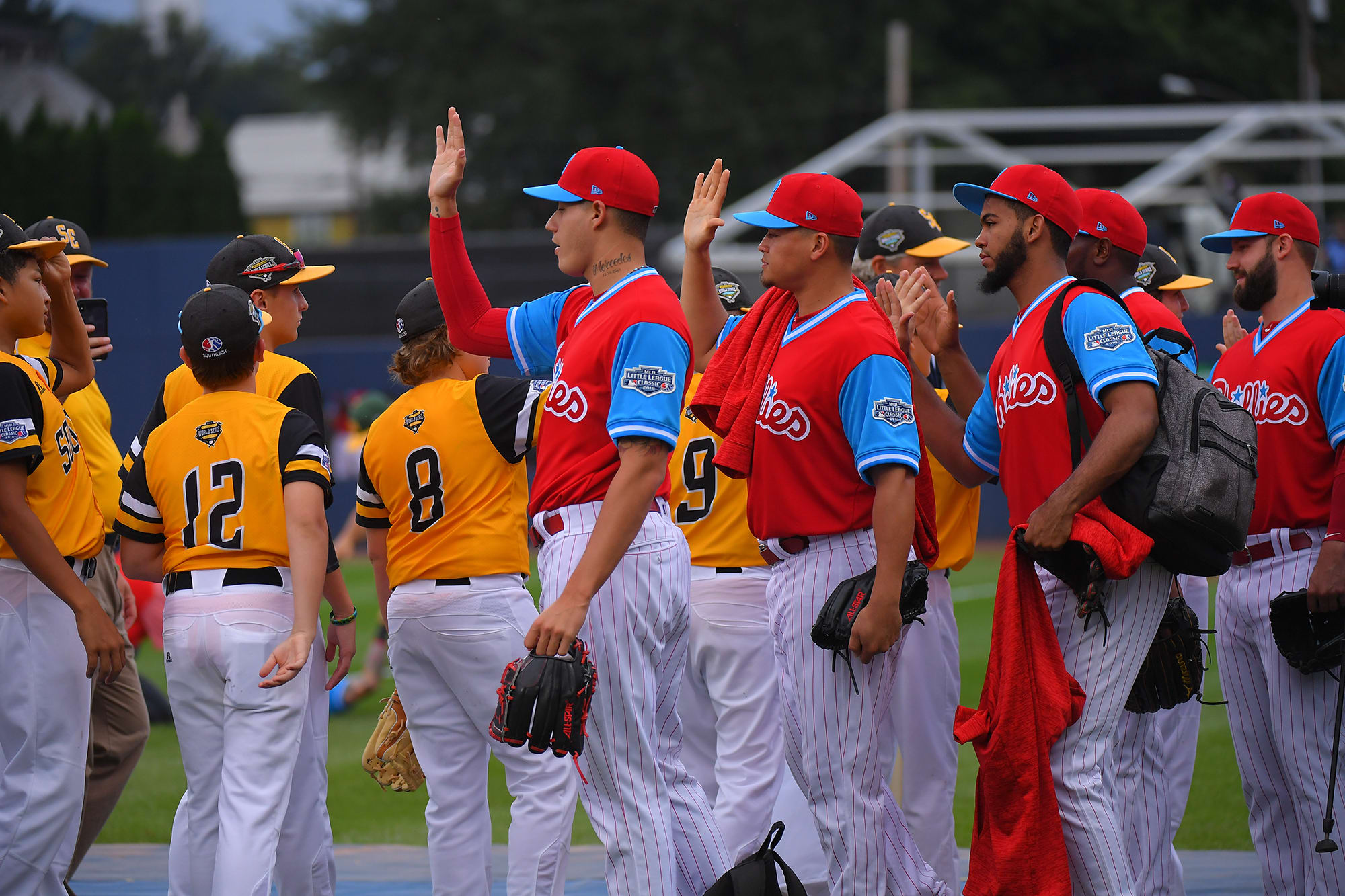 mlb players high fiving kids