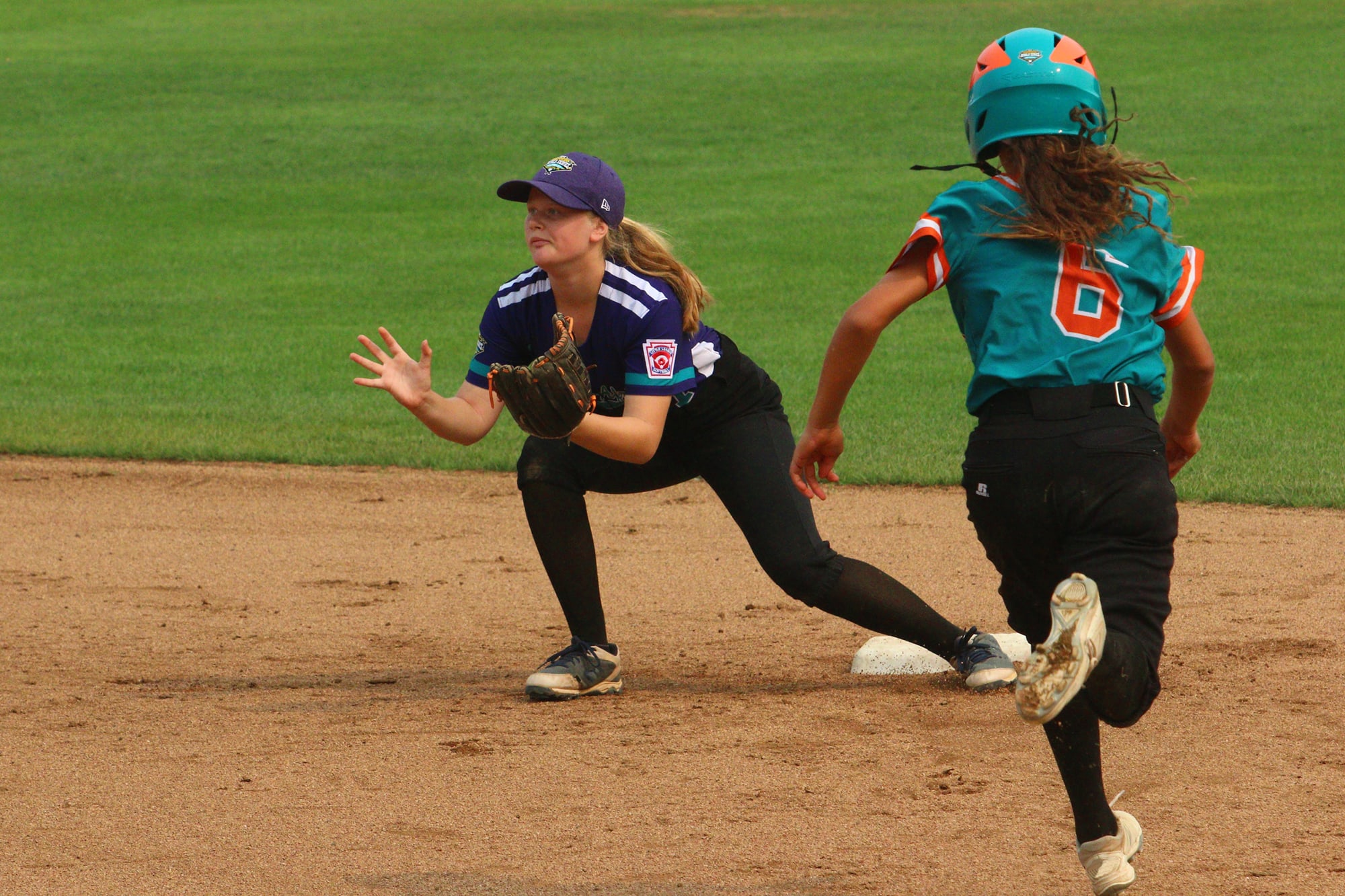 softball player catching ball on second