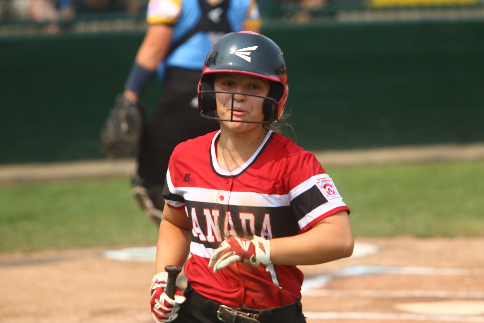 softball player running dugout