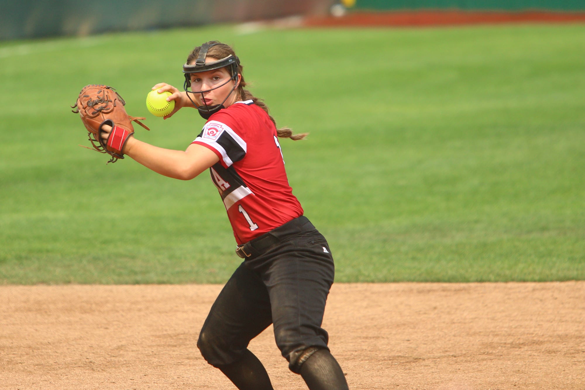 softball player throwing ball