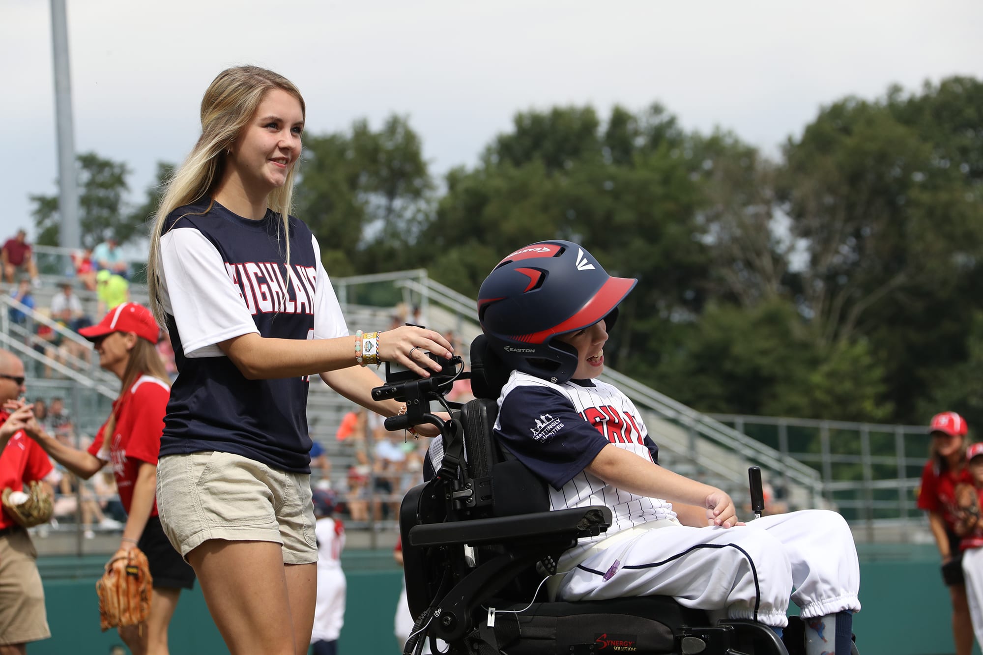 challenger game - buddy pushing player in wheelchair