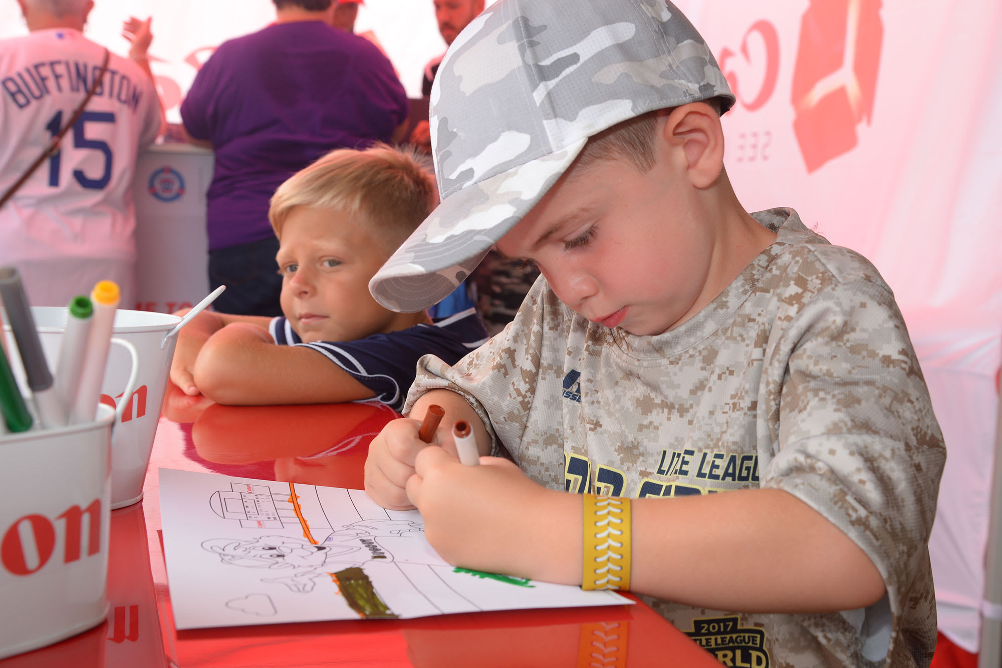 two boys coloring at canon station