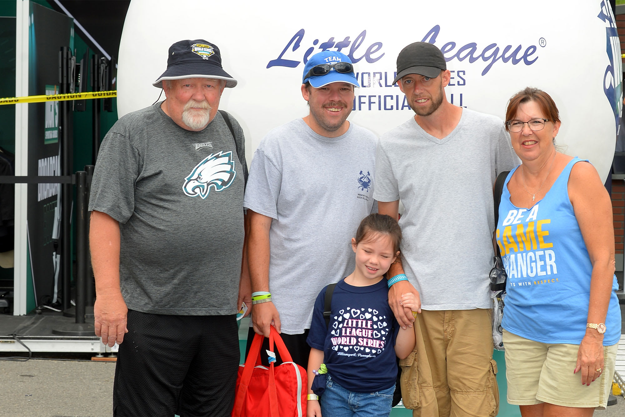 family picture in front of large baseball