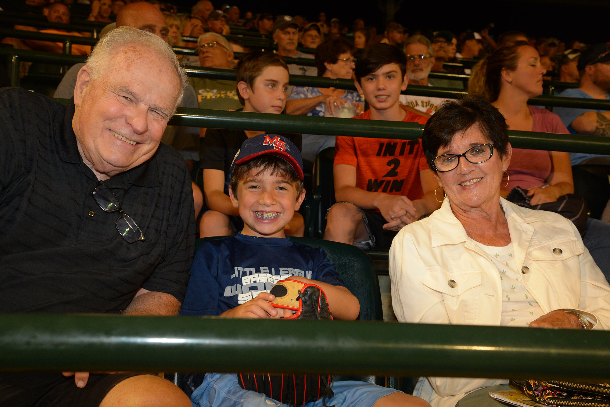 grandparents with grandson baseball game