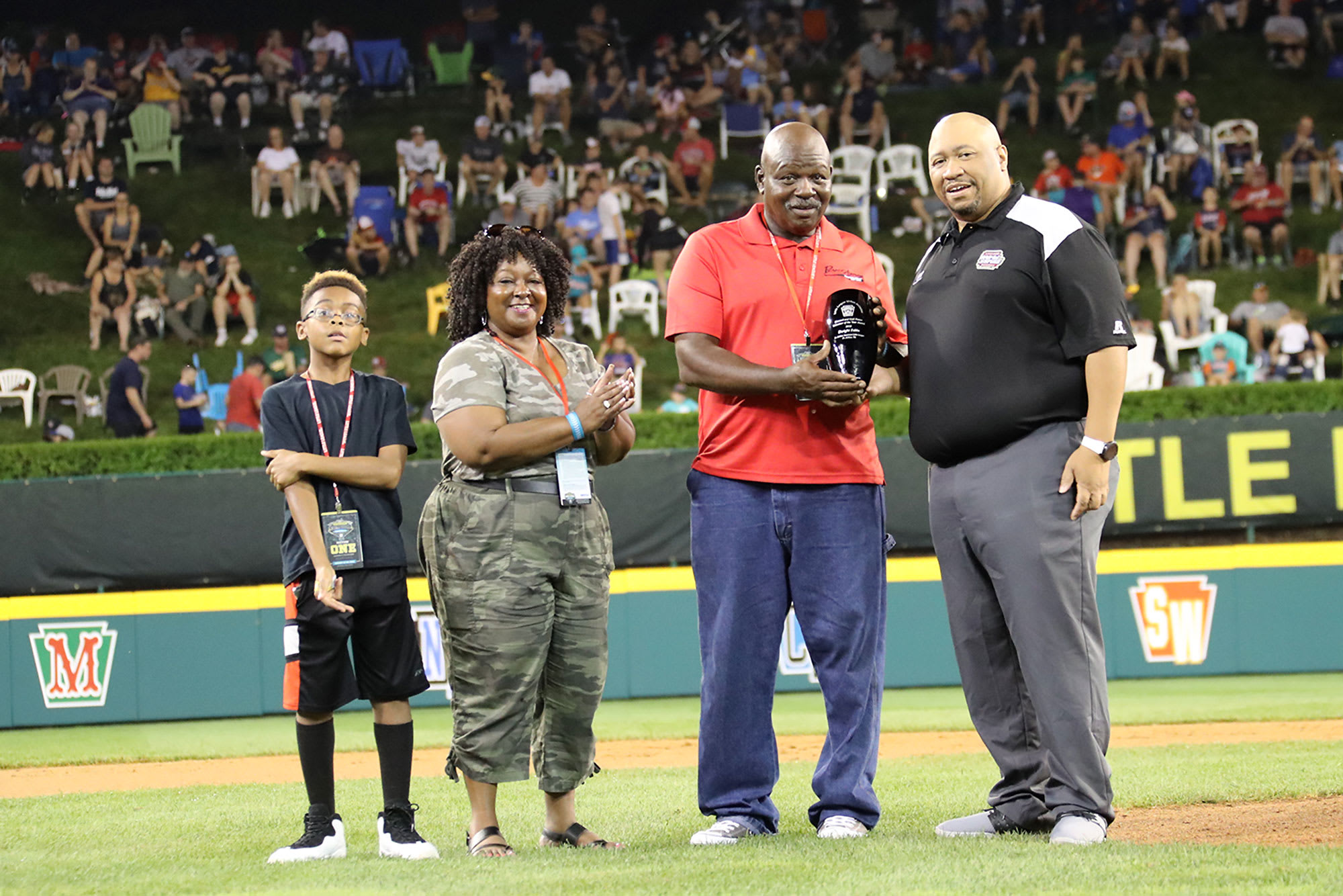 urban initiative award winner holding award